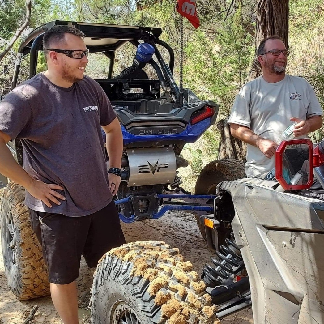 SxSWeRide riders discussing machines on the trail